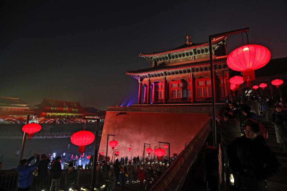 Visitors tour the Forbidden City decorated with red lanterns and illuminated with lights during the Lantern Festival in Beijing, Tuesday, Feb. 19, 2019. Beijing's Palace Museum was illuminated and opened for night visits to celebrate China's Lantern Festival. For the first time since it was established 94 years ago, the Palace Museum, also known as the Forbidden City, extended opening hours till nighttime and lit up part of its cultural relics buildings. (AP Photo/Andy Wong)