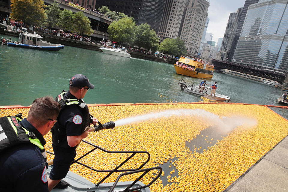 <p>A fire hose is used to help guide rubber ducks down the Chicago River during the Windy City Rubber Ducky Derby on August 3, 2017 in Chicago, Illinois. (Photo: Scott Olson/Getty Images) </p>