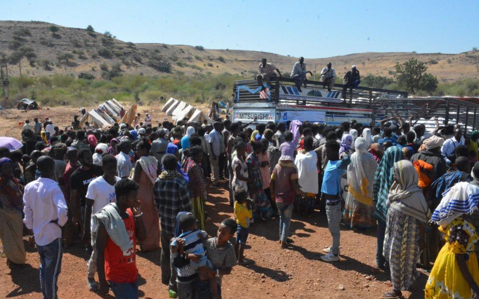 Refugees gather at an Islamic Relief food distribution in Um Rakuba refugee camp, Gedaref state, eastern Sudan - Omar Araky/Islamic Relief HANDOUT/EPA-EFE/Shutterstock /Shutterstock