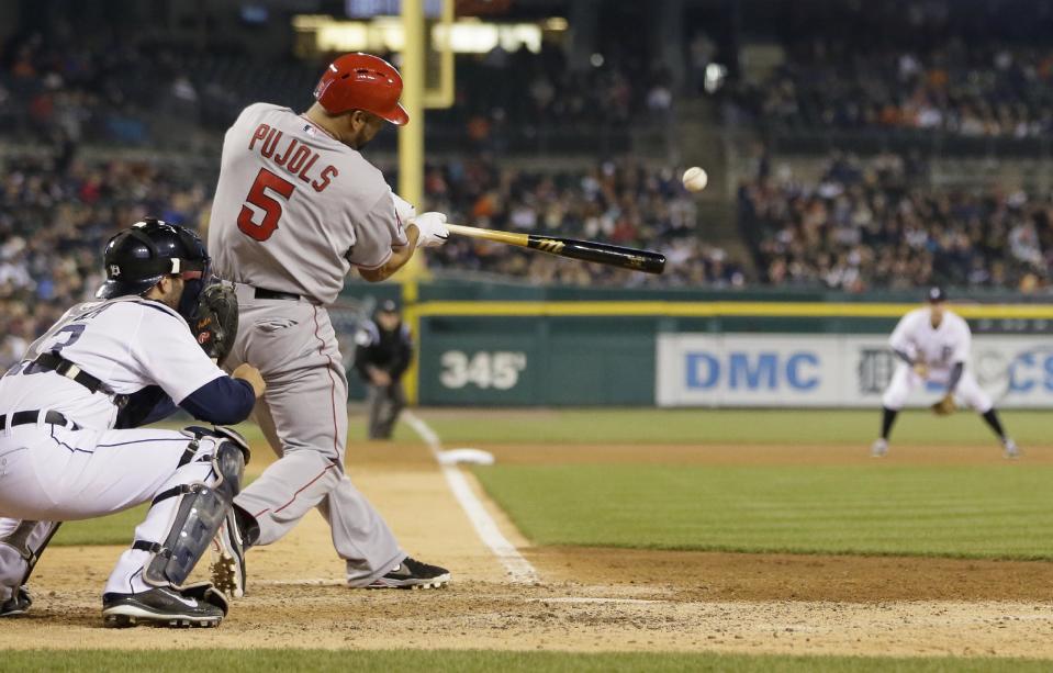 Los Angeles Angels' Albert Pujols (5) connects for a three-run home run during the sixth inning of a baseball game against the Detroit Tigers in Detroit, Friday, April 18, 2014. (AP Photo/Carlos Osorio)