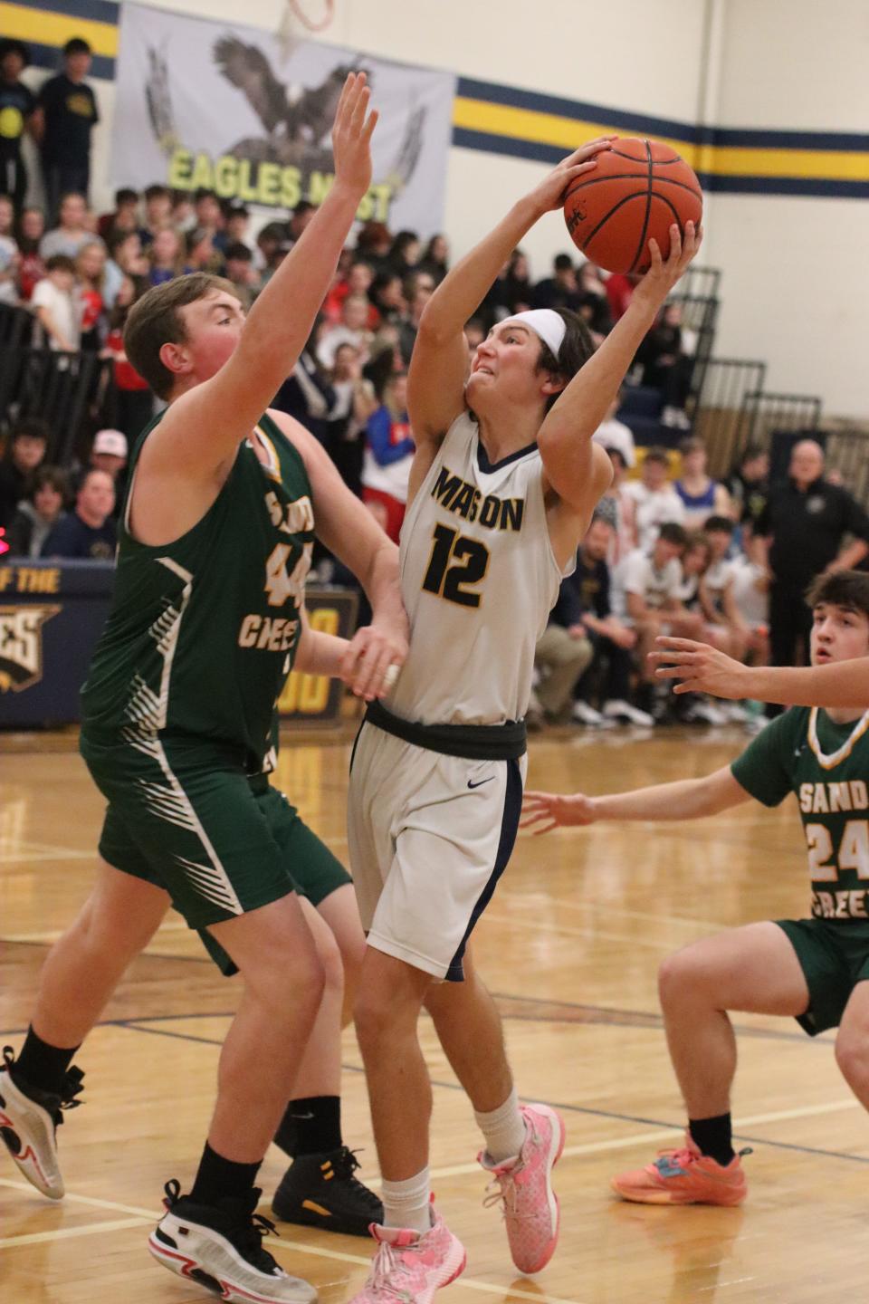 Erie Mason's Korbin Herrera looks for a lane against Sand Creek on Thursday, January 5, 2023.