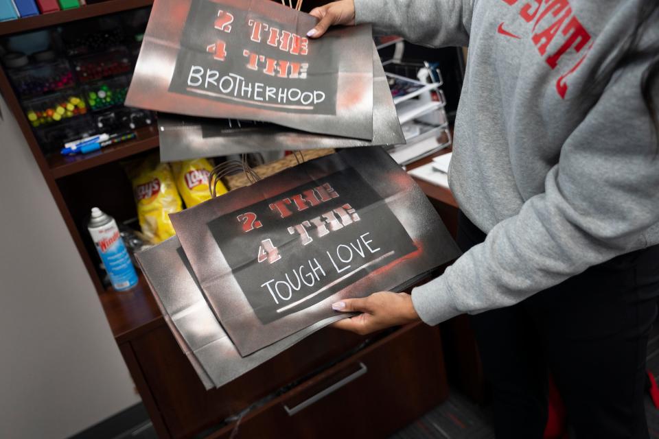 Erin Dunston, Ohio State football's director of on-campus recruiting, sifts through customized bags that will be given to visiting recruits.