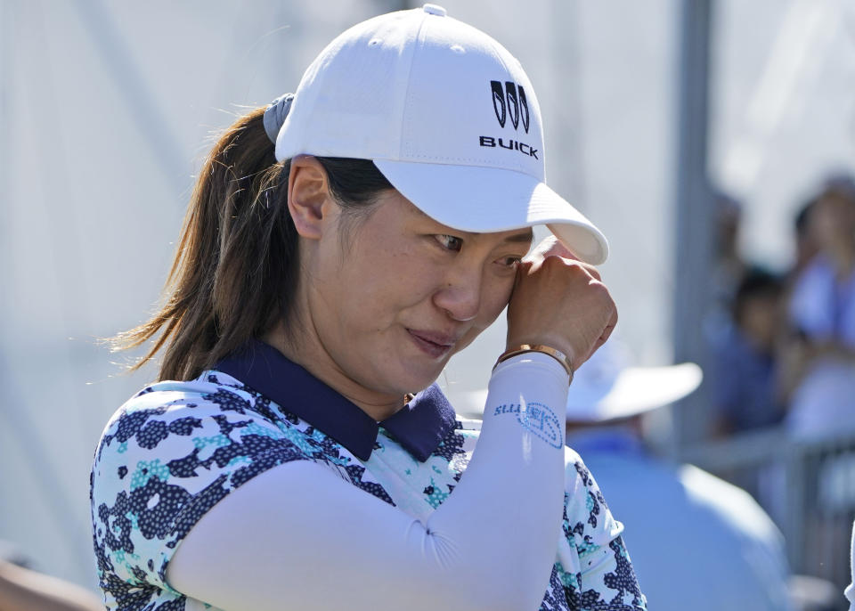 Xiyu Janet Lin, of China, wipes away tears after the final round of the LPGA The Ascendant golf tournament in The Colony, Texas, Sunday, Oct. 2, 2022. (AP Photo/LM Otero)