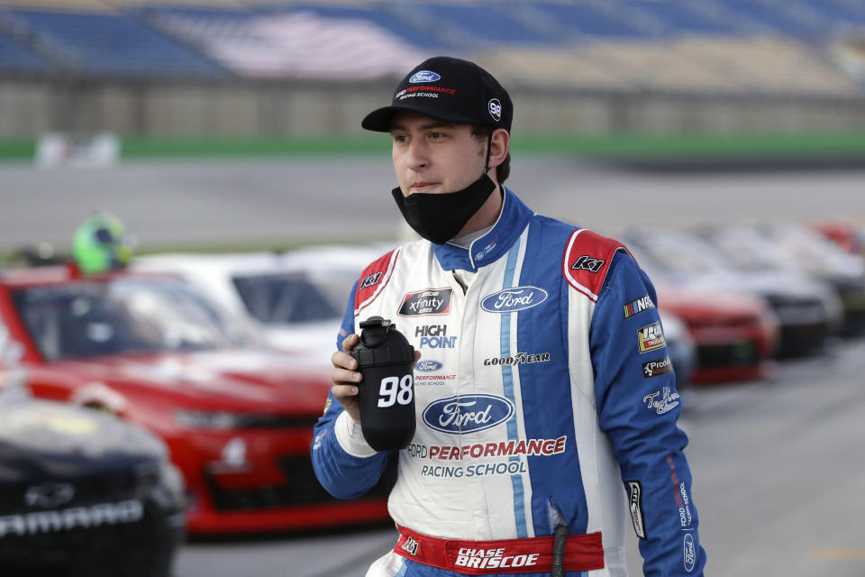 FILE - In this Thursday, July 9, 2020, file photo, Chase Briscoe walks the infield before a NASCAR Xfinity Series auto race in Sparta, Ky. Briscoe is very clear about his goal of earning a promotion to NASCAR's top Cup Series. He's made his case this season with an Xfinity Series-leading five victories with an eye on adding another win Saturday on the road course at Road America. (AP Photo/Mark Humphrey, File)