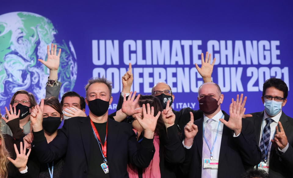 Delegates pose for a picture during the UN Climate Change Conference (COP26) in Glasgow, Scotland, Britain November 13, 2021. REUTERS/Yves Herman