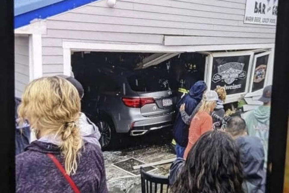 In this photo released by the Laconia Fire Department, a vehicle sits inside a restaurant after crashing through the wall on Sunday, July 2, 2023, in Laconia, NH. The car struck the busy Looney Bin Bar & Grill and injured more than a dozen patrons inside, authorities said. (Laconia Fire Department via AP)