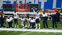 Chicago Bears Roquan Smith (58), Josh Woods (55), Joel Iyiegbuniwe (45) and James Vaughters (93) listen during the national anthem before an NFL football game against the Detroit Lions in Detroit, Sunday, Sept. 13, 2020. (AP Photo/Paul Sancya)
