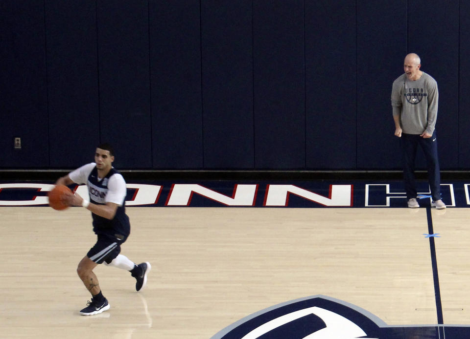 Connecticut coach Dan Hurley, right, screams at forward Kwintin William during the team's first NCAA college basketball practice on Saturday, Sept. 29, 2018 in Storrs, Conn. The team opened practice a day after the NCAA notified the school of violations during former coach Kevin Ollie's tenure there. (AP Photo/Pat Eaton-Robb)