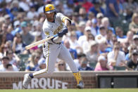 Milwaukee Brewers' Jackson Chourio swings into a single off Chicago Cubs starting pitcher Jameson Taillon during the fifth inning of a baseball game Saturday, May 4, 2024, in Chicago. (AP Photo/Charles Rex Arbogast)