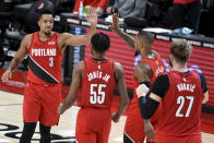 Portland Trail Blazers guard CJ McCollum, left, celebrates with teammates after hitting a shot to give the Blazers the lead late in overtime of an NBA basketball game against the Houston Rockets in Portland, Ore., Saturday, Dec. 26, 2020. The Blazers won 128-126. (AP Photo/Steve Dykes)