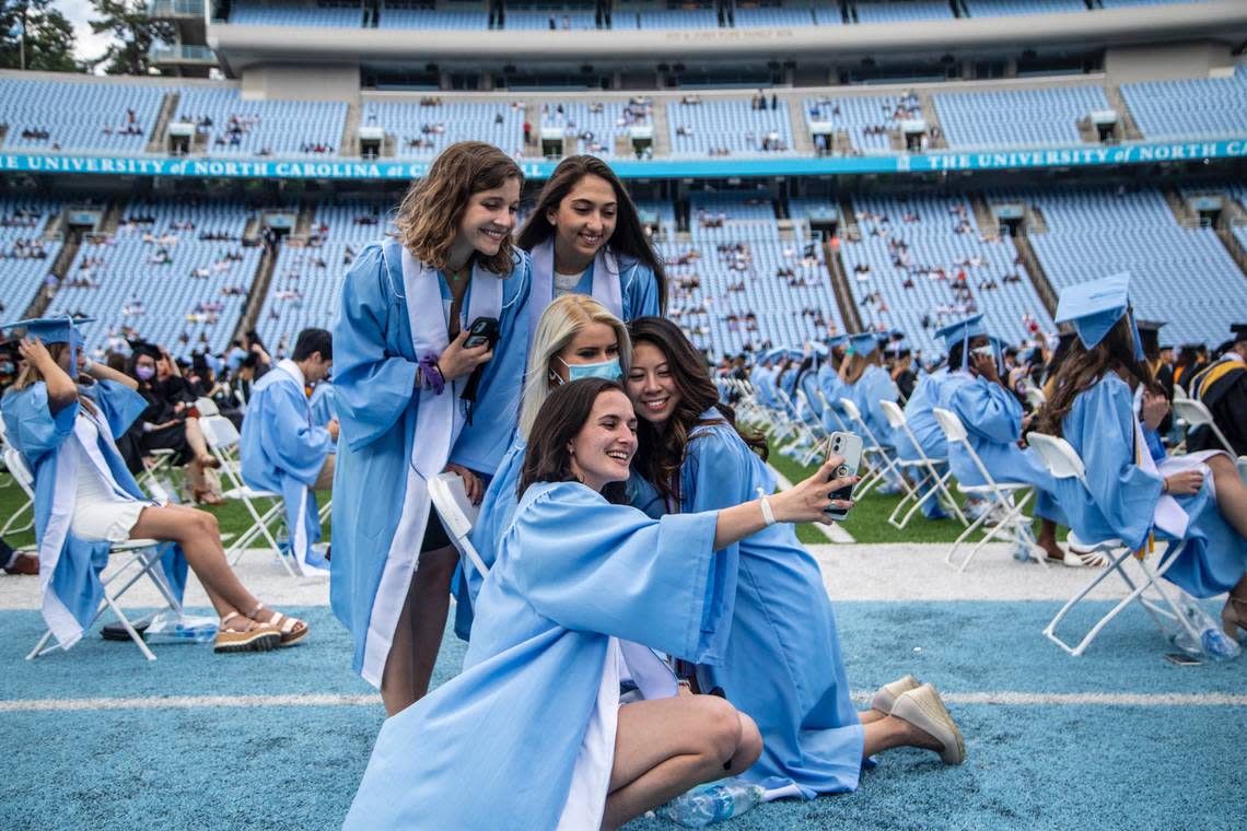 Students gather for a “selfie” prior to a commencement ceremony at UNC-Chapel Hill Friday, May 14, 2021.