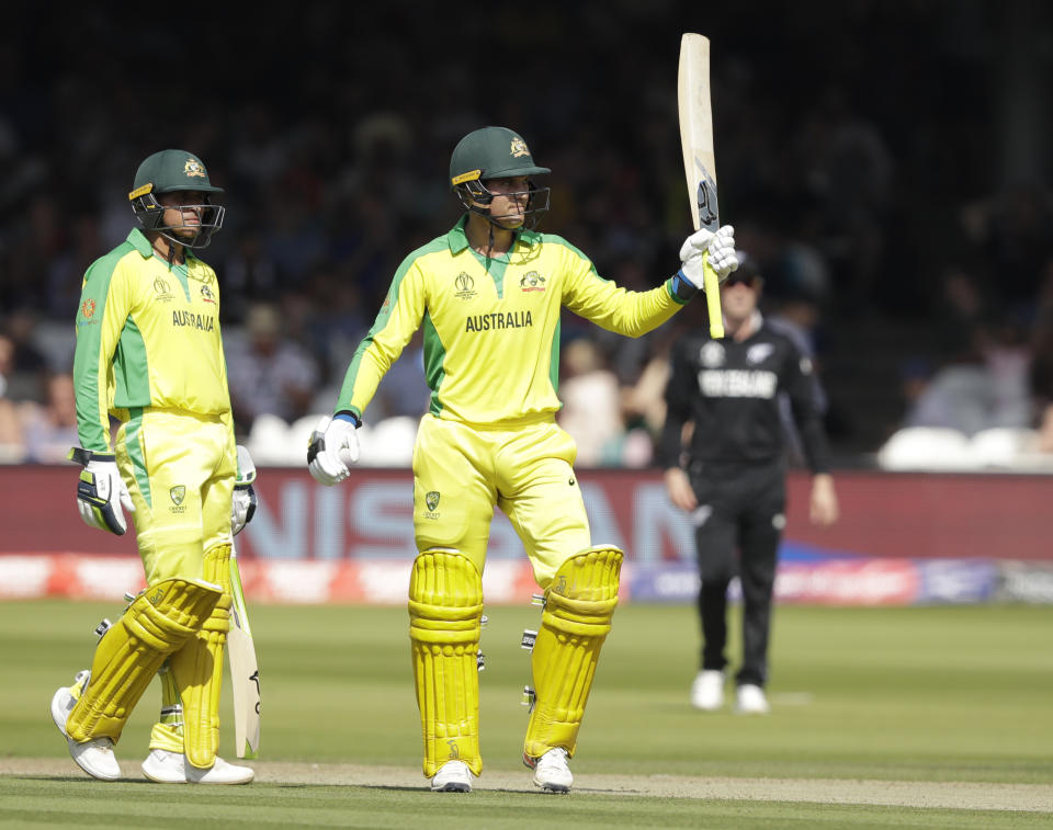 Australia's Alex Carey , right celebrates getting 50 runs not out with teammate Australia's Usman Khawaja during the Cricket World Cup match between New Zealand and Australia at Lord's cricket ground in London, Saturday, June 29, 2019. (AP Photo/Matt Dunham)