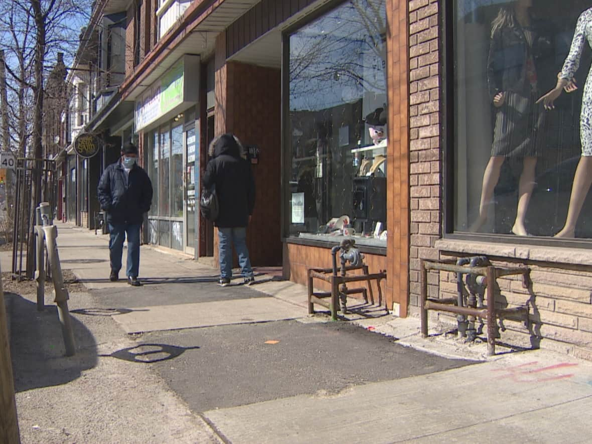 Those patched-over stretches of sidewalk on Dundas West have tripped up at least five people and led to complaints to the city from residents and the local BIA. (MIke Smee/CBC - image credit)