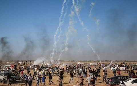 Israeli security forces fire tear gas canisters over Palestinians near Khan Yunis, Gaza  - Credit: Anadolu