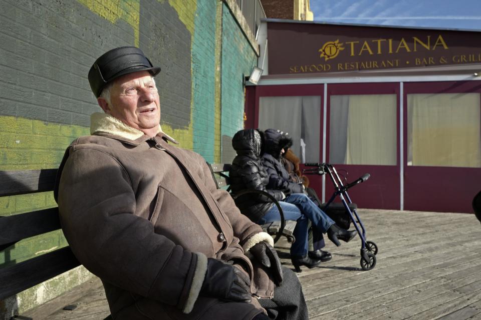 In this Dec. 16, 2016 photo, Yuriy Taras enjoys the sunshine while sitting on the Brighton Beach boardwalk in the Brooklyn borough of New York. Originally from Ukraine, Taras considers Trump's nomination of Exxon Mobil CEO Rex Tillerson, "a person who knows both Putin and Russia," as secretary of state, a sign that the "enmity" between Washington and Moscow will be on the mend. (AP Photo/Mark Lennihan)