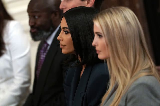 <p>Alex Wong/Getty</p> Kim Kardashian sits with Ivanka Trump