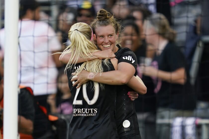 Angel City FC midfielder Savannah McCaskill, right, celebrates with forward Tyler Lussi.