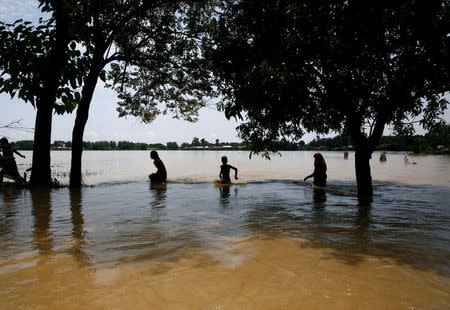 Flood victims walk along he flooded area in Saptari District, Nepal August 14, 2017. REUTERS/Navesh Chitrakar