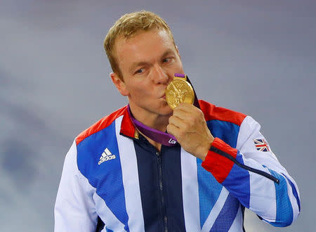 FILE PHOTO: Britain's Chris Hoy kisses his gold medal during the victory ceremony for the track cycling men's keirin event at the Velodrome during the London 2012 Olympic Games, UK, August 7, 2012. REUTERS/Cathal McNaughton/File Photo