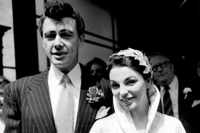 <p>PA Images via Getty</p> Maxwell Reed and Joan Collins after their wedding at Caxton Hall Register Office, London