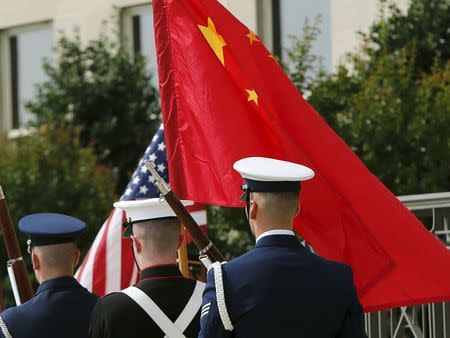 A U.S. military honor guard carries the flags of both the United States and the People's Republic of China before U.S. Secretary of Defense Ash Carter welcomes China's Vice-Chairman of the Central Military Commission General Fan Changlong (not pictured) at the Pentagon in Washington June 11, 2015. REUTERS/Gary Cameron