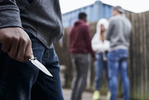 <span class="caption">Knife crime is at record levels across the UK.</span> <span class="attribution"><a class="link " href="https://www.shutterstock.com/image-photo/close-teenage-boy-urban-gang-holding-1433575952" rel="nofollow noopener" target="_blank" data-ylk="slk:SpeedKingz/Shutterstock;elm:context_link;itc:0;sec:content-canvas">SpeedKingz/Shutterstock</a></span>