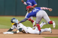 Oakland Athletics' Ramon Laureano, bottom, is tagged out trying to steal second base by Toronto Blue Jays shortstop Bo Bichette during the seventh inning of a baseball game in Oakland, Calif., Monday, July 4, 2022. (AP Photo/Jeff Chiu)