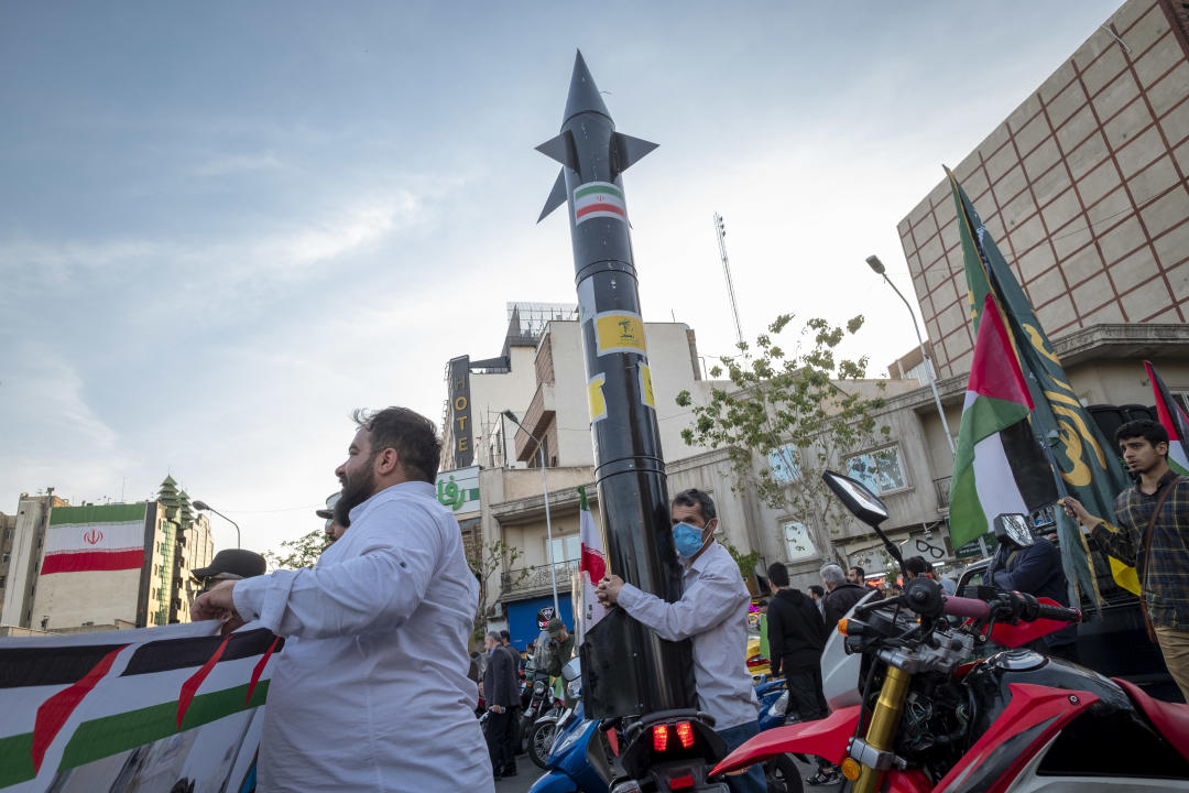 An unidentified man is holding a model of Iran's first-ever hypersonic missile, Fattah, during a gathering to celebrate the IRGC UAV and missile attack against Israel, in Tehran, Iran, on April 15, 2024. Iran launched dozens of Unmanned Aerial Vehicles (UAVs) and missiles against Israel on April 13th in response to the Israeli attack on its Consulate in Damascus. (Photo by Morteza Nikoubazl/NurPhoto via Getty Images)