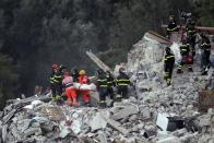 <p>Rescuers recover a lifeless body from a collapsed house following an earthquake in Pescara Del Tronto, Italy, Wednesday, Aug. 24, 2016. (AP Photo/Gregorio Borgia) </p>