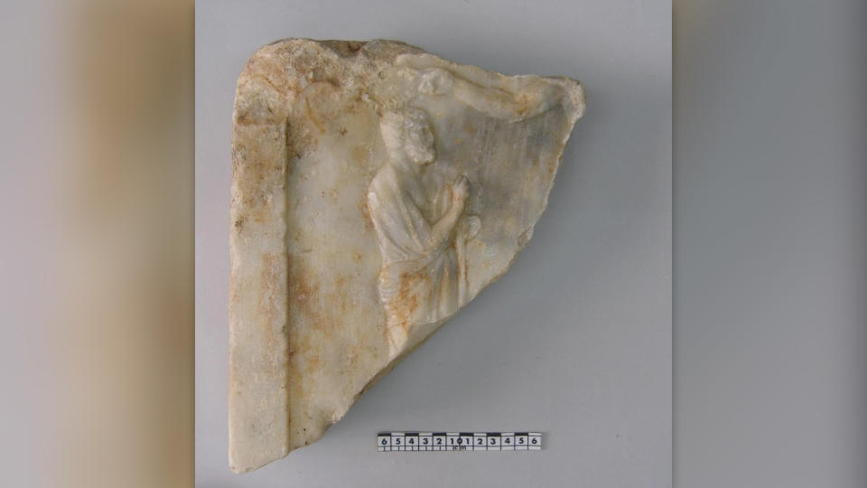 The upper portion of a fourth-century-B.C. marble stele with the relief of a bearded man.