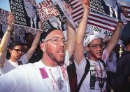 <p>The radical HIV/AIDS direct action group ACT UP began in New York in March 1987. They staged demonstrations across the country and the movement spread across the world. Here, protesters partake in a 1991 action march outside the White House, at which they chained themselves to the gates, and to each other, in protest against President Bush’s inaction during the crisis. </p>