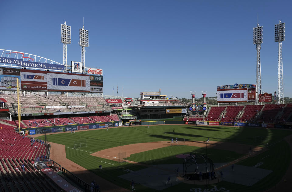 Fans watch players warm up for a baseball game between the Chicago Cubs and the Cincinnati Reds at Great American Ball Park in Cincinnati on Friday, April 30, 2021. (AP Photo/Jeff Dean)