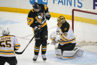 Boston Bruins goaltender Tuukka Rask (40) blocks a shot with Pittsburgh Penguins' Jeff Carter (77) screening him during the first period of an NHL hockey game in Pittsburgh, Tuesday, April 27, 2021.(AP Photo/Gene J. Puskar)