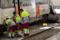 <p>Railway technicians check a train wagon at the Estacio de Franca (Franca station) in central Barcelona on July 28, 2017 after a regional train appears to have hit the end of the track inside the station injuring dozens of people. (Photo: Miquel Llop/NurPhoto via Getty Images) </p>