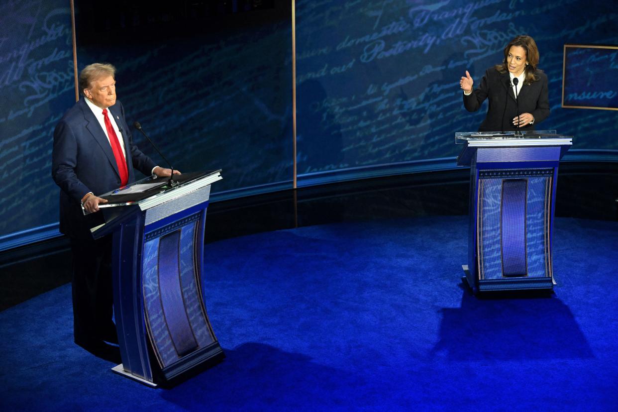 U.S. Vice President and Democratic presidential candidate Kamala Harris (R) speaks as former U.S. President and Republican presidential candidate Donald Trump listens during a presidential debate at the National Constitution Center in Philadelphia, Pennsylvania, on September 10, 2024.