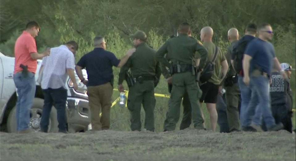 In this frame grab taken from video provided by KRGV, authorities stage near where a helicopter flying over the U.S.-Mexico border in Texas crashed, killing two National Guard soldiers and a Border Patrol agent, Friday, March 8, 2024. (KRGV via AP)