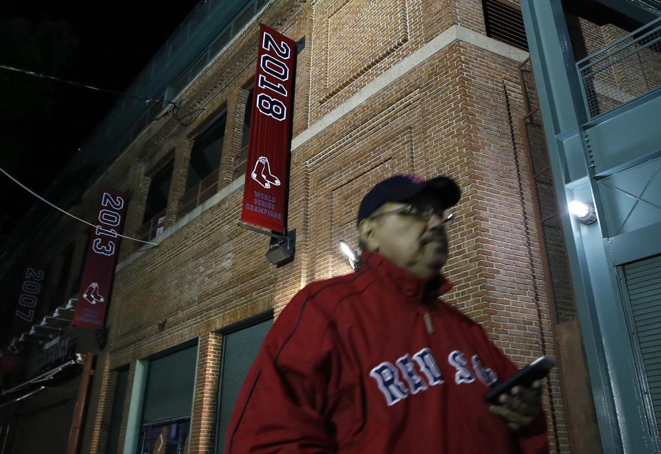 The 2018 World Series baseball championship banner hangs outside Fenway Park in Boston, Monday, Oct. 29, 2018. The Boston Red Sox won the series against the Los Angeles Dodgers on Sunday in Los Angeles. (AP Photo/Michael Dwyer)