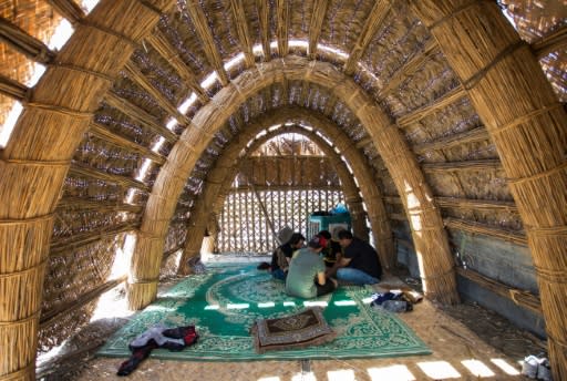 Visitors picnick and paddle along the river, and there's even a floating home made of elaborately woven palm reeds