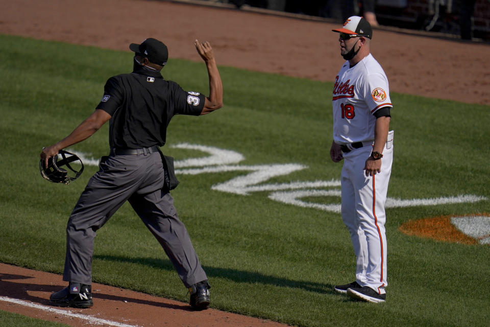 Home plate umpire Jeremie Rehak, left, ejects Baltimore Orioles manager Brandon Hyde, right, during the fourth inning of a baseball game, Thursday, April 8, 2021, on Opening Day in Baltimore. Hyde argued against a call on a pitch from Red Sox's Eduardo Rodriguez that hit Orioles' Rio Ruiz but wasn't awarded first base on a check swing strike. (AP Photo/Julio Cortez)