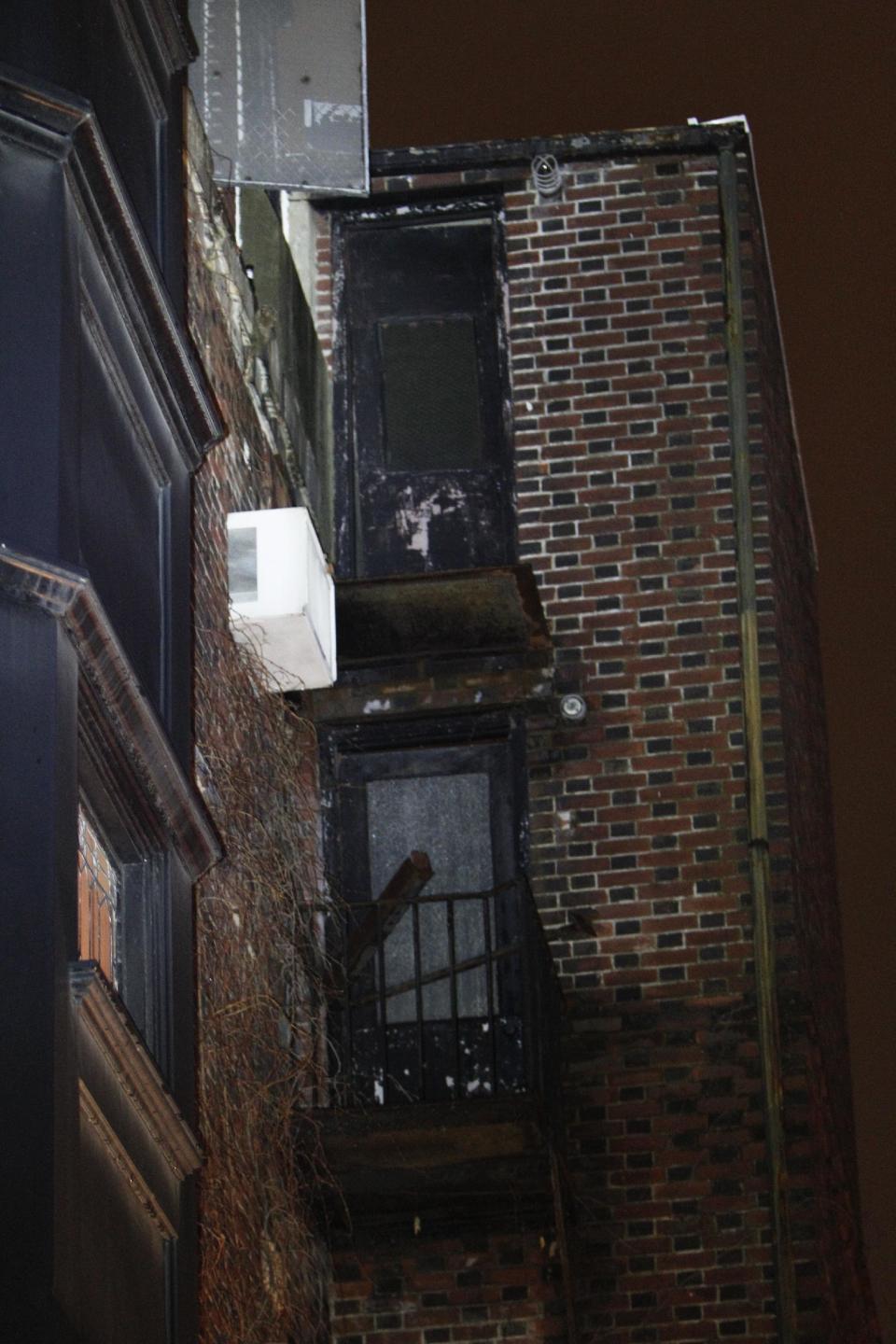 The balcony that collapsed around midnight Saturday in the Rittenhouse Square section of Philadelphia is seen Sunday, Jan. 12, 2014, killing a young man and injuring two women, police said. Police say a 22-year-old man who suffered severe head and neck injuries in the fall was pronounced dead at a hospital early Sunday morning. The two women are in their 20s and suffered broken bones in their backs. They are listed in stable condition at two city hospitals. The man and two women, who were attending a birthday party, had stepped out onto the balcony to smoke cigarettes when the collapse occurred, authorities said. (AP Photo/ Joseph Kaczmarek)