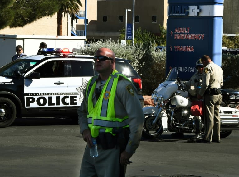 Police keep watch outside the trauma department at the University Medical Center in Las Vegas