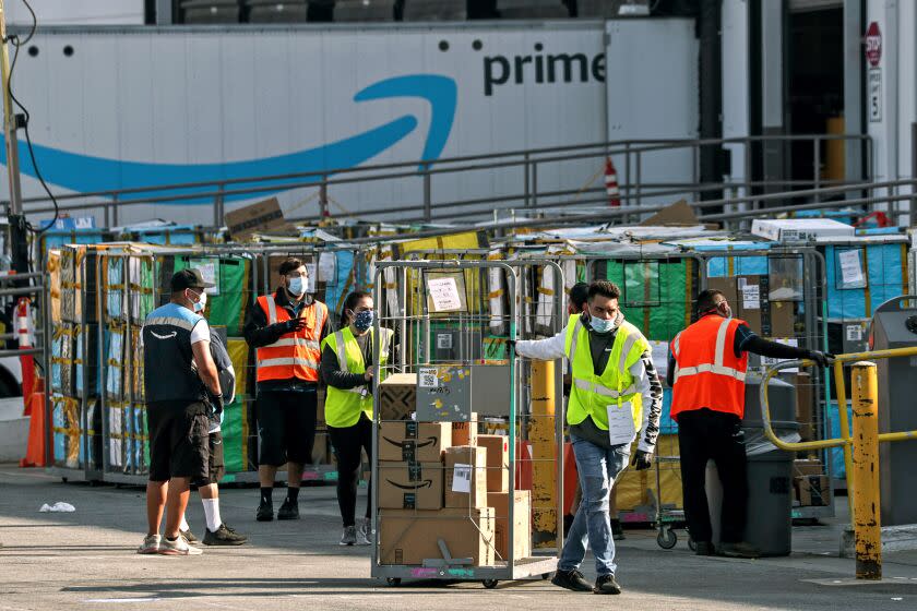 HAWTHORNE, CA - MAY 01: Delivery vans leave Amazon warehouse facility in Hawthorne. Hawthorne, CA. (Irfan Khan / Los Angeles Times)