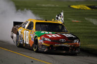 RICHMOND, VA - APRIL 28: Kyle Busch, driver of the #18 M&M's Ms. Brown Toyota, celebrates with a burnout and the checkered flag after winning the NASCAR Sprint Cup Series Capital City 400 at Richmond International Raceway on April 28, 2012 in Richmond, Virginia. (Photo by Streeter Lecka/Getty Images)