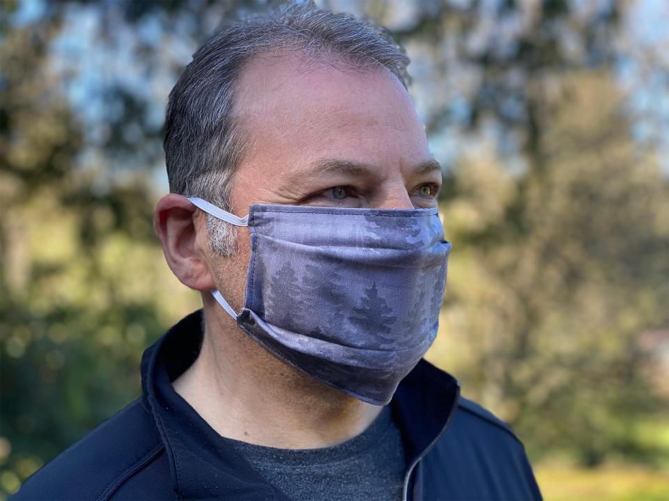 Craig Harris models fabric face masks sewn and given away free by his wife, artist Tara Reed, in Portland, Oregon in March 2020. Reed is among entrepreneurs pivoting as the country confronts the coronavirus pandemic.