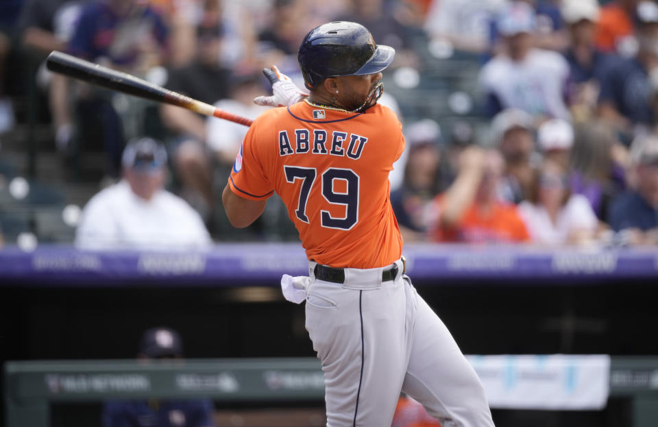 Houston Astros' Jose Abreu follows the flight of his single against Colorado Rockies starting pitcher Austin Gomber in the second inning of a baseball game Wednesday, July 19, 2023, in Denver. (AP Photo/David Zalubowski)