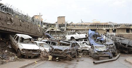 Dozen of cars piled up on top of each other in the parking lot of Moore Hospital after a tornado struck Moore, Oklahoma in this file photo from May 20, 2013. REUTERS/Gene Blevins/Files