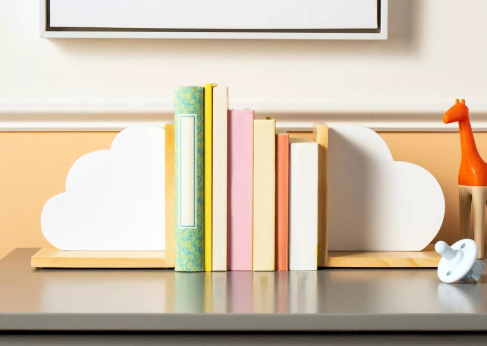 Bookshelf with books between the bookends, giraffe figurine on the side, for children's room decor