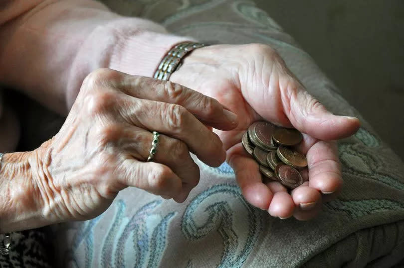 Elderly woman counting loose change