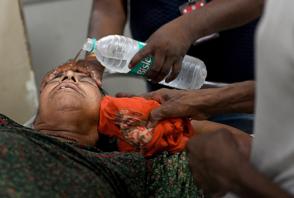 Hospital staff pour water for a patient who is suffering from heatstroke in a government hospital in Varanasi, India, during a heat wave on May 30, 2024. / Credit: Indranil Aditya/NurPhoto via Getty Images