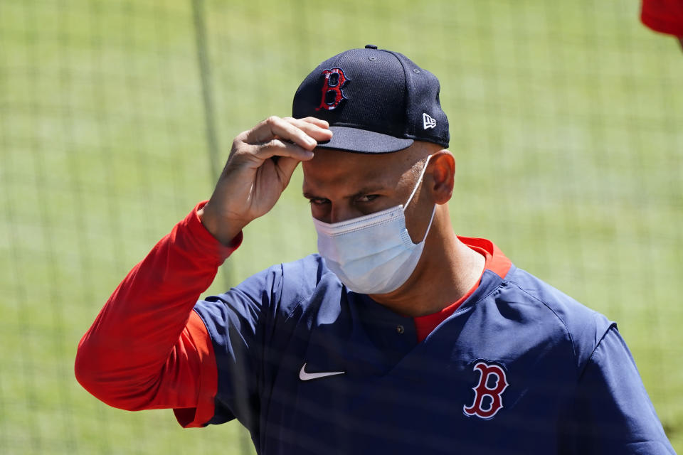 Boston Red Sox manager Alex Cora walks to the dugout before first inning of a spring training baseball game against the Baltimore Orioles Thursday, March 4, 2021, in Sarasota, Fla.. (AP Photo/John Bazemore)